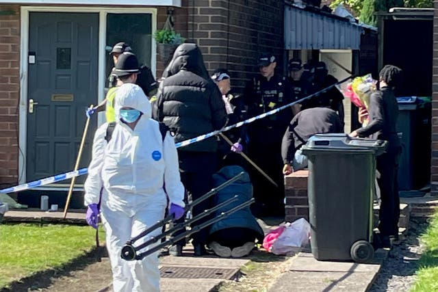 <p>Police officers at the scene in Lovett Avenue, Oldbury after a 13-year-old boy was stabbed to death at a house, sparking a murder investigation (Phil Barnett/PA)</p>