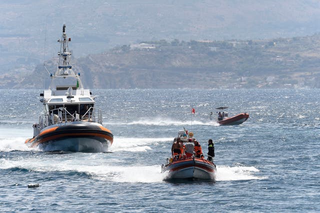 <p>Emergency services at the scene of the search for a missing boat, in Porticello, southern Italy on August 20. Rescue teams and divers returned to the site of a storm-sunken superyacht Tuesday to search for six people, including British tech magnate Mike Lynch, who are believed to be still trapped in the hull 50 meters underwater. </p>